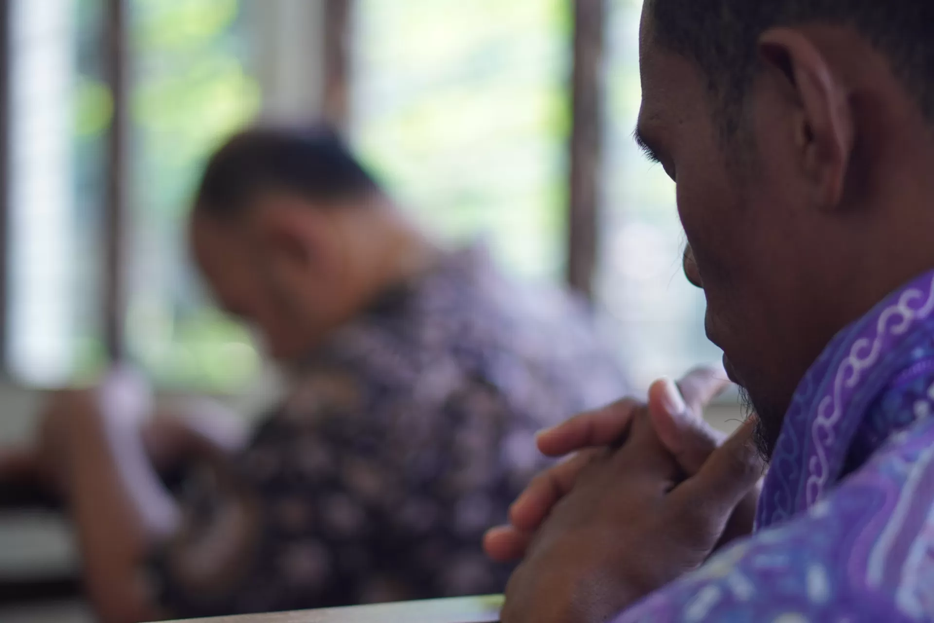 A church member with folded hands in prayer
